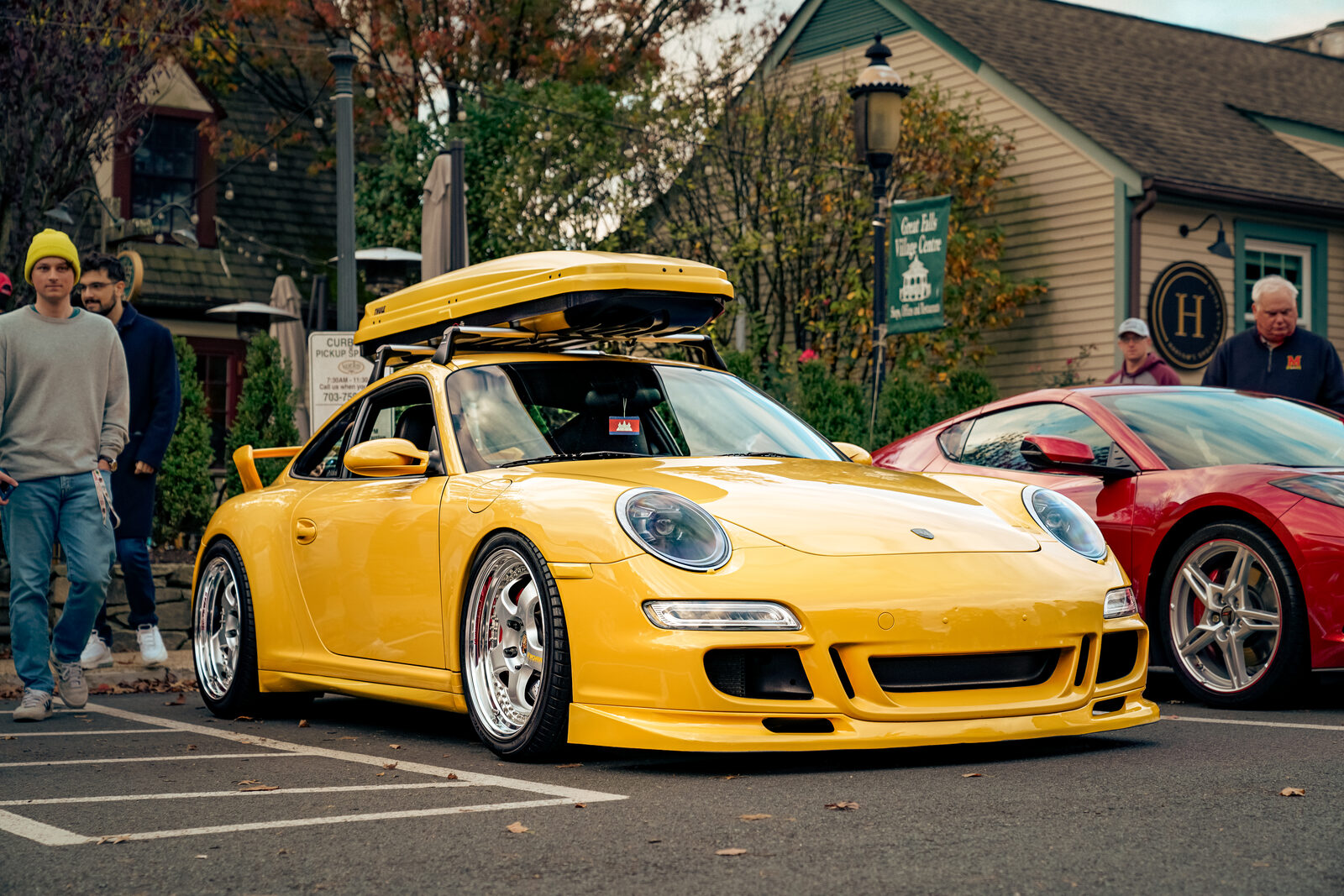 A yellow Porsche 911 GT3, full car, front three-quarter view at a DMV car meet.