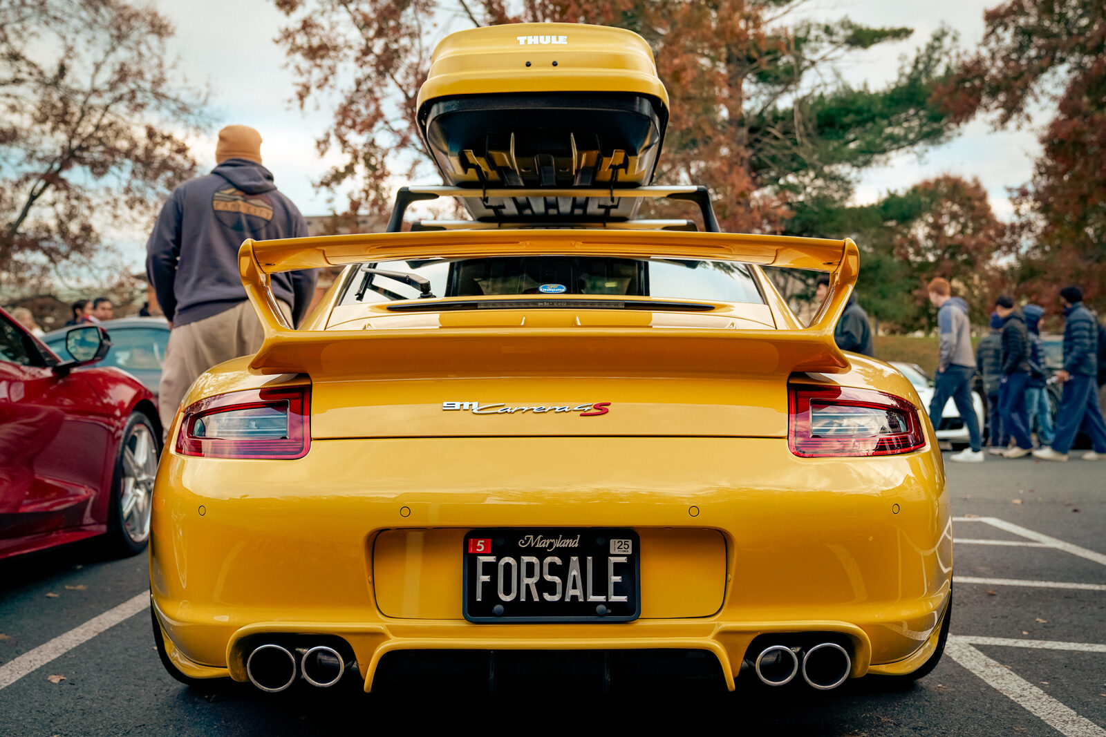 A yellow Porsche 911 GT2 with a for-sale license plate.