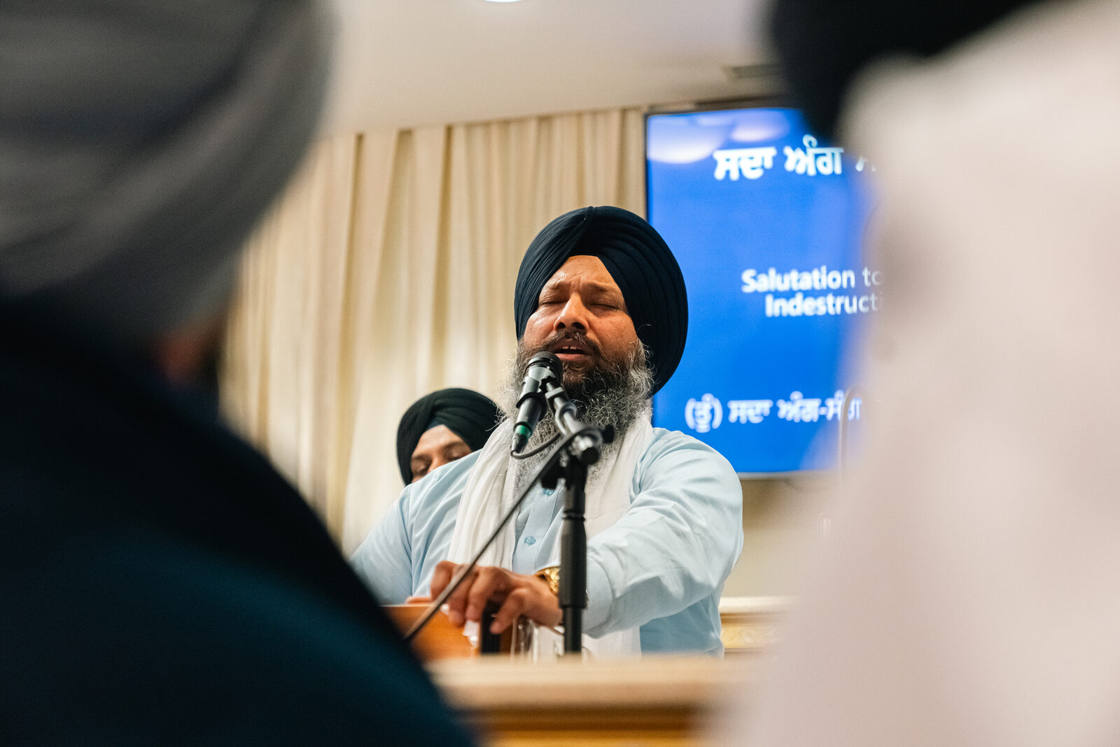 A speaker addressing the crowd from a podium at the celebration.