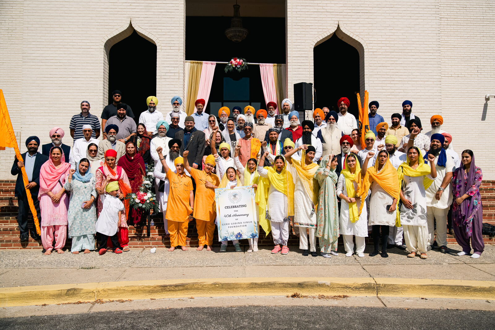 A large community group photo outside the gurdwara celebrating the 40th anniversary.