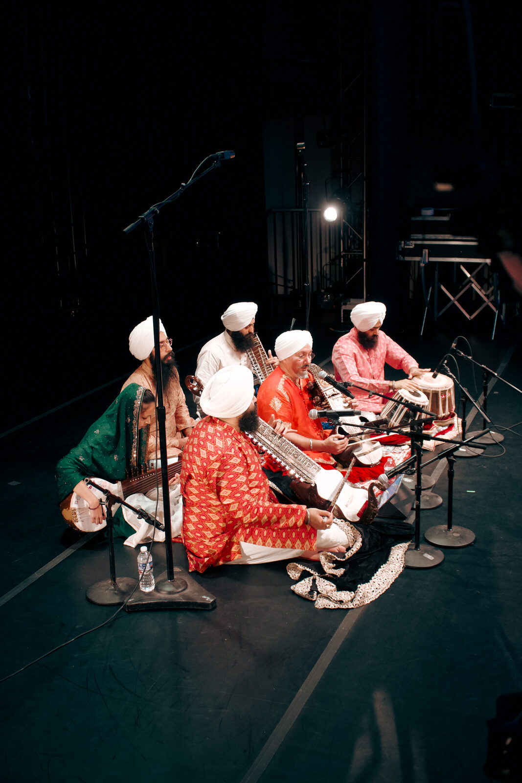 A classical music ensemble performing together on stage.