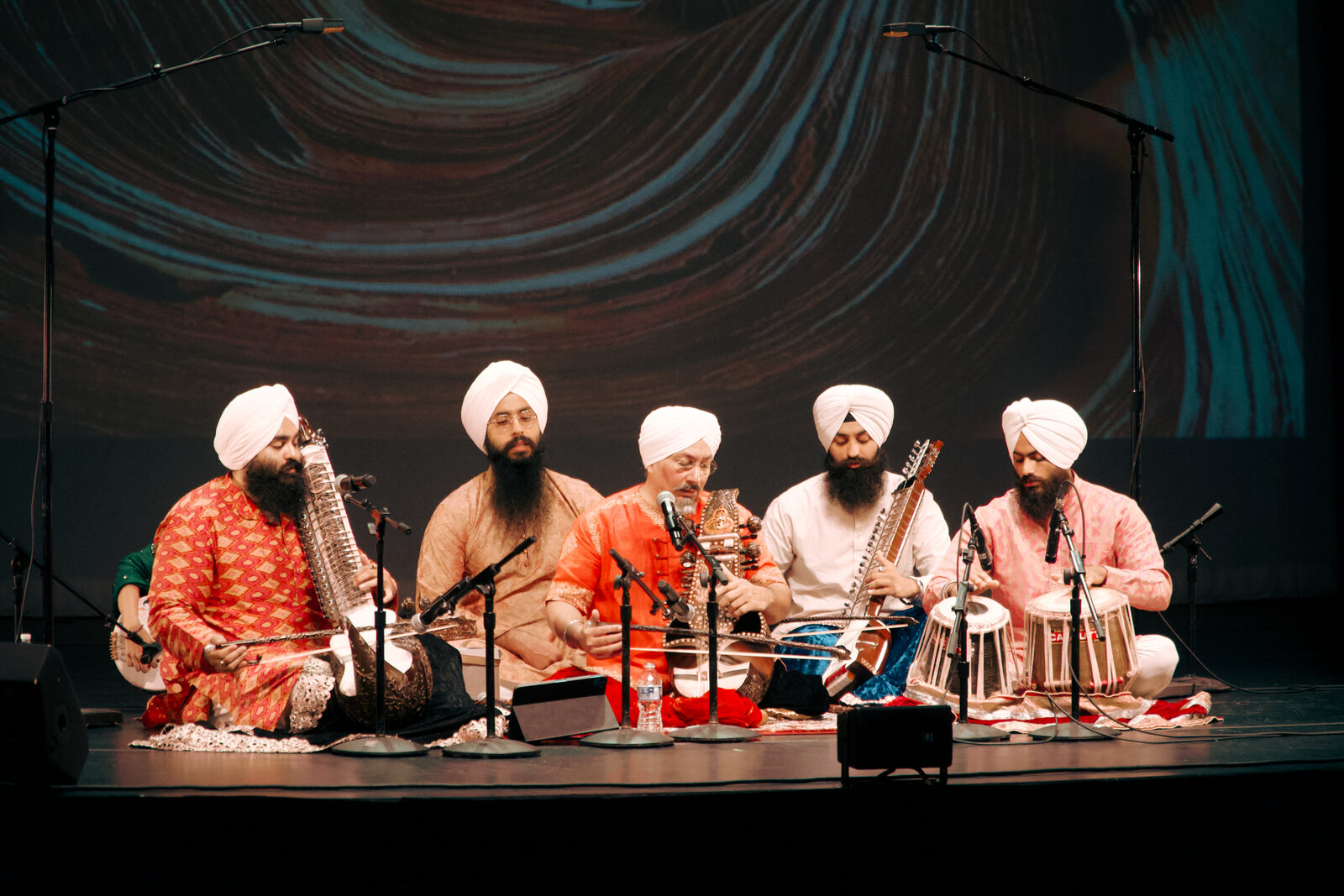 A wide shot of the classical ensemble performing on stage.