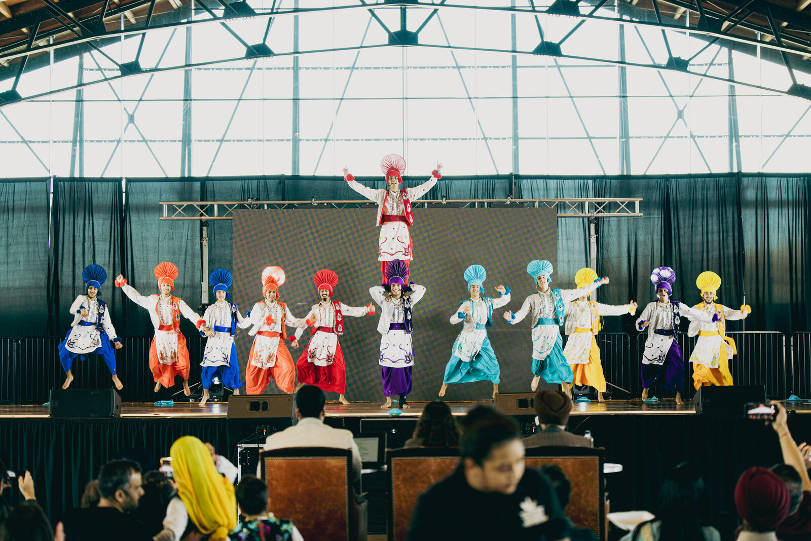 Bhangra team in a closing pyramid formation on the main stage.