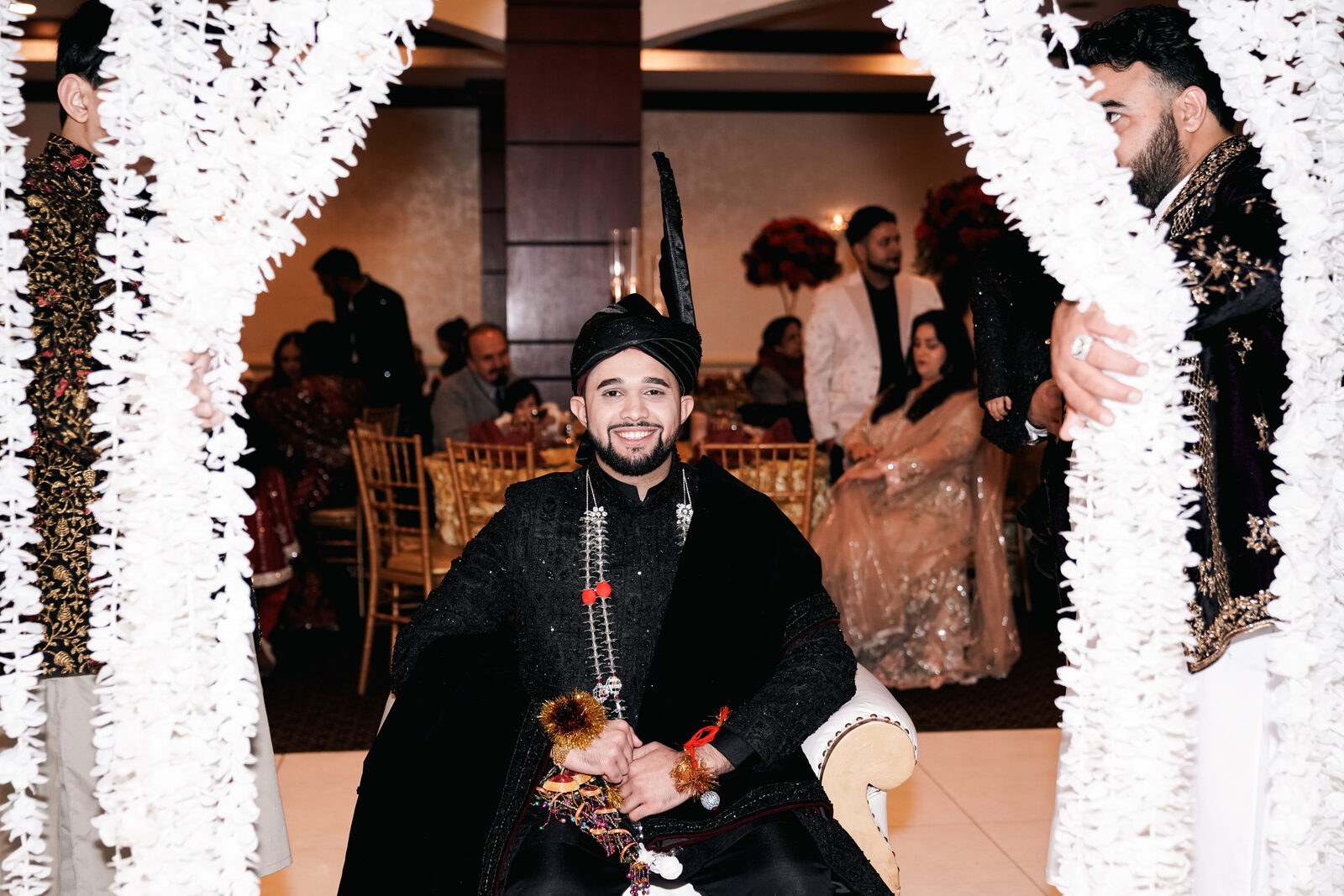 Groom's portrait in a black sherwani and turban at the reception.